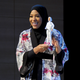 U.S. Olympic medalist Ibtihaj Muhammad speaks onstage holding the new Barbie doll made in her image during an event at the Brooklyn Museum in New York City on Nov. 13, 2017. (Craig Barritt/Getty Images for Glamour)